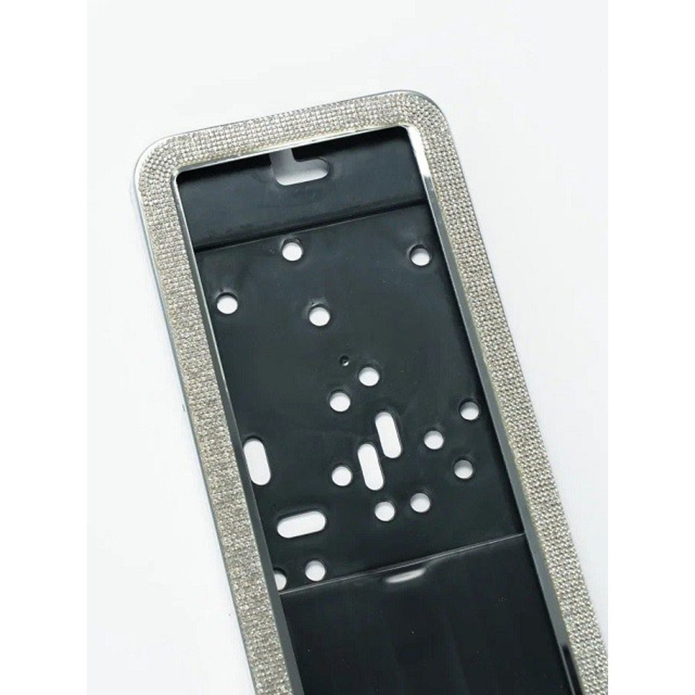 Рамка номерного знака с серебристыми стразами (комп.) Рамка номерного знака с серебристыми стразами (комп.)